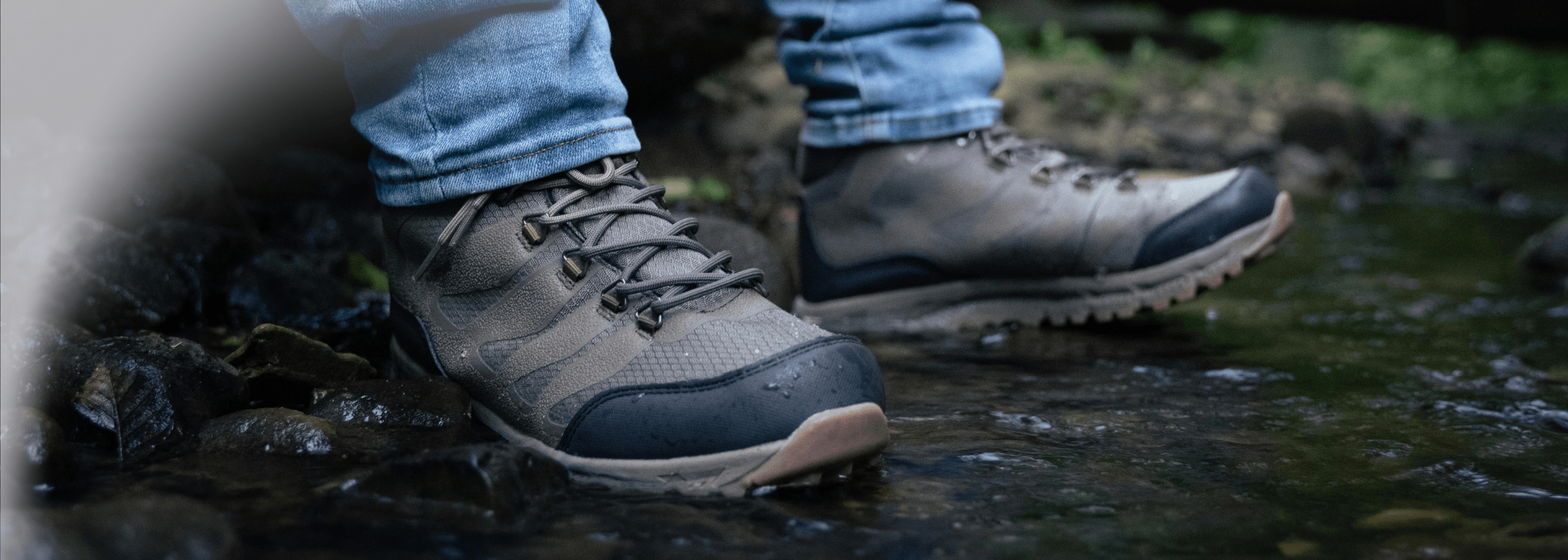 hiking boots for men in the water of a river to show they are waterproof